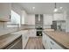 Modern kitchen with white cabinets, wood countertops, and a farmhouse sink at 18302 Gypsy Ave, Port Charlotte, FL 33954