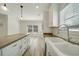 Modern kitchen with white cabinets, wood countertops, and a large island at 18302 Gypsy Ave, Port Charlotte, FL 33954