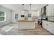 Modern kitchen with white cabinets, wood countertops, and stainless steel appliances at 18302 Gypsy Ave, Port Charlotte, FL 33954