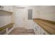 Laundry room with built-in bench, wood countertop, and ample storage at 18302 Gypsy Ave, Port Charlotte, FL 33954
