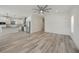 Open living area with wood-look floors and a ceiling fan at 18302 Gypsy Ave, Port Charlotte, FL 33954