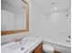 Clean bathroom with single vanity, tub, and shower at 18399 Fremont Ave, Port Charlotte, FL 33954