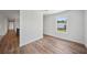 Spacious bedroom featuring wood-look floors and a large window at 18399 Fremont Ave, Port Charlotte, FL 33954