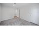 Well-lit bedroom with grey carpet and access to hallway at 18399 Fremont Ave, Port Charlotte, FL 33954