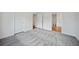 Bright bedroom with grey carpet and access to a bathroom at 18399 Fremont Ave, Port Charlotte, FL 33954