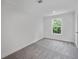 Bright bedroom featuring grey carpet and a large window at 18399 Fremont Ave, Port Charlotte, FL 33954