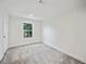Bright bedroom with grey carpet and a window with garden view at 18399 Fremont Ave, Port Charlotte, FL 33954