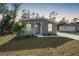Single-story home with grey siding, front porch, and yard at 18399 Fremont Ave, Port Charlotte, FL 33954