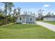 Single-story home with grey siding, front porch, and yard at 18399 Fremont Ave, Port Charlotte, FL 33954