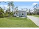 Single-story home with grey siding, front porch and driveway at 18399 Fremont Ave, Port Charlotte, FL 33954