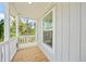 Wooden porch with white railings and window at 18399 Fremont Ave, Port Charlotte, FL 33954