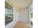 Wooden porch with white door and window at 18399 Fremont Ave, Port Charlotte, FL 33954