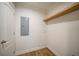 Laundry room with wood-look floors, shelving and a door at 18399 Fremont Ave, Port Charlotte, FL 33954