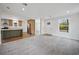 Open living room with kitchen view and gray carpet at 18399 Fremont Ave, Port Charlotte, FL 33954
