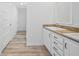 Double vanity bathroom with wood countertop and modern fixtures at 19095 Willard Ave, Port Charlotte, FL 33954