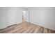 Well-lit bedroom with wood-look flooring and access to other rooms at 19095 Willard Ave, Port Charlotte, FL 33954
