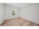 Simple bedroom with wood-look floors and a window with blinds at 19095 Willard Ave, Port Charlotte, FL 33954