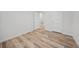 Bright bedroom featuring wood-look floors and access to hallway at 19095 Willard Ave, Port Charlotte, FL 33954