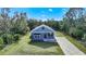 Single-story home with gray siding, front porch, and driveway at 19095 Willard Ave, Port Charlotte, FL 33954