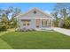 Gray house with a covered porch and a landscaped yard at 19095 Willard Ave, Port Charlotte, FL 33954