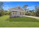 Cute gray house with a covered porch and well-manicured lawn at 19095 Willard Ave, Port Charlotte, FL 33954