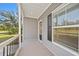 Inviting front porch with gray siding and black shutters at 19095 Willard Ave, Port Charlotte, FL 33954