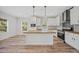 Modern kitchen with white cabinets, wood countertops, and island at 19095 Willard Ave, Port Charlotte, FL 33954