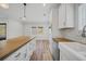 Modern kitchen with white cabinets, butcher block countertops and farmhouse sink at 19095 Willard Ave, Port Charlotte, FL 33954