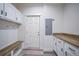 Functional laundry area with white cabinets, wood countertop and exterior access at 19095 Willard Ave, Port Charlotte, FL 33954