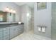 Spa-like bathroom with gray cabinets, marble shower, and modern vanity at 195 W Pine Valley Ln, Rotonda West, FL 33947