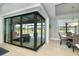 View of the pool through sliding glass doors from the dining area at 195 W Pine Valley Ln, Rotonda West, FL 33947