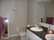 Bathroom with double sinks, toilet and large mirror at 22507 Provance Ave, Port Charlotte, FL 33954