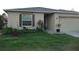 House exterior featuring a well-maintained lawn and landscaping at 22507 Provance Ave, Port Charlotte, FL 33954