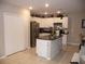 Modern kitchen with stainless steel appliances and an island at 22507 Provance Ave, Port Charlotte, FL 33954