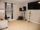 Living room with tiled floors, large TV, and music equipment at 22507 Provance Ave, Port Charlotte, FL 33954