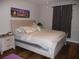 Main bedroom with a king-size bed and wood flooring at 22507 Provance Ave, Port Charlotte, FL 33954