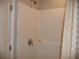 Clean shower with white tile and built-in shelf at 22507 Provance Ave, Port Charlotte, FL 33954