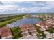 Aerial view of luxury condo near lake, highlighting its location and features at 23536 Awabuki Dr # 4B, Venice, FL 34293