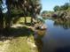 Scenic backyard featuring beautiful waterfront views and lush greenery, ideal for relaxation at 328 Baytree Dr, Rotonda West, FL 33947