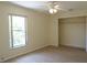 Bedroom featuring ceiling fan and large window at 328 Baytree Dr, Rotonda West, FL 33947