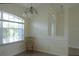 Inviting dining area with arched window and elegant chandelier, perfect for Gathering gatherings and entertaining guests at 328 Baytree Dr, Rotonda West, FL 33947