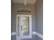 Elegant front door with decorative glass and transom window, offering a grand entrance to the home at 328 Baytree Dr, Rotonda West, FL 33947