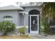 Charming front door with decorative screen and well-maintained landscaping, creating a welcoming entrance at 328 Baytree Dr, Rotonda West, FL 33947