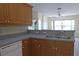 Functional kitchen with a stainless steel sink and view of the bright and spacious living area, ideal for cooking at 328 Baytree Dr, Rotonda West, FL 33947