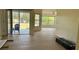Spacious living area with sliding glass doors leading to the outside, featuring new flooring and great natural light at 328 Baytree Dr, Rotonda West, FL 33947