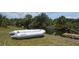 Waterfront property featuring a boat and a dock, offering direct access to the serene canal at 328 Baytree Dr, Rotonda West, FL 33947