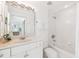 Clean bathroom with white fixtures, marble countertop, and bathtub with shower at 45 Seawatch Lake Dr, Boca Grande, FL 33921