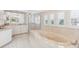 This elegant bathroom features a jacuzzi tub under shuttered windows, a glass enclosed shower, and vanity area at 45 Seawatch Lake Dr, Boca Grande, FL 33921