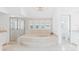 This elegant bathroom boasts a jacuzzi tub under shuttered windows and a glass enclosed shower at 45 Seawatch Lake Dr, Boca Grande, FL 33921