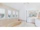 This elegant bathroom boasts a jacuzzi tub under shuttered windows and a vanity area at 45 Seawatch Lake Dr, Boca Grande, FL 33921